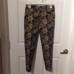 Lined black and gold embellished ankle pant.